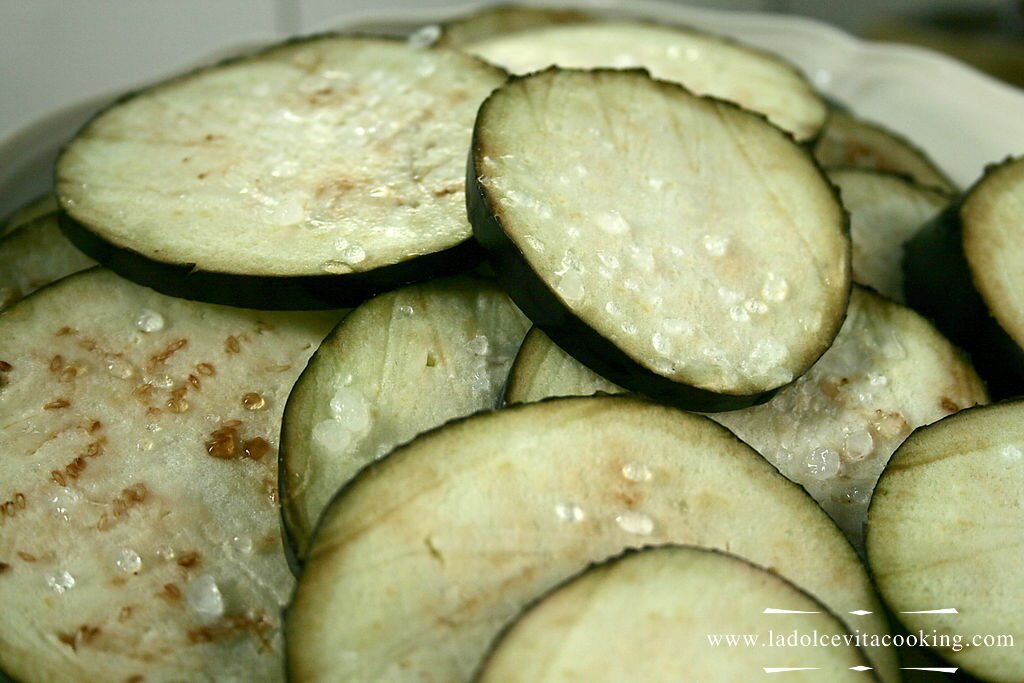 Sliced eggplants covered with salt